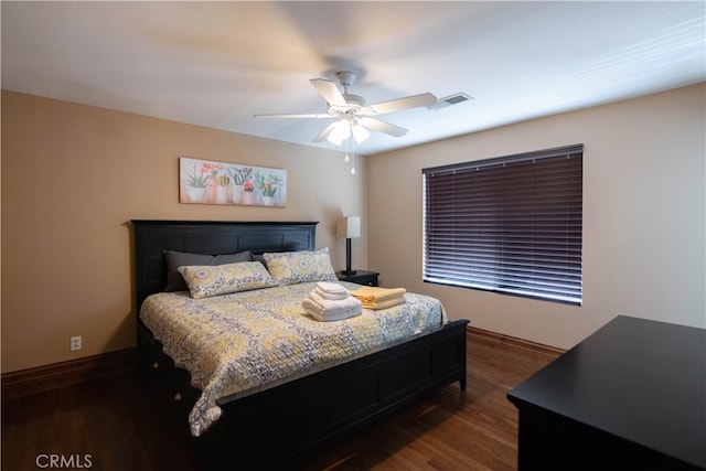 bedroom with ceiling fan and dark hardwood / wood-style floors