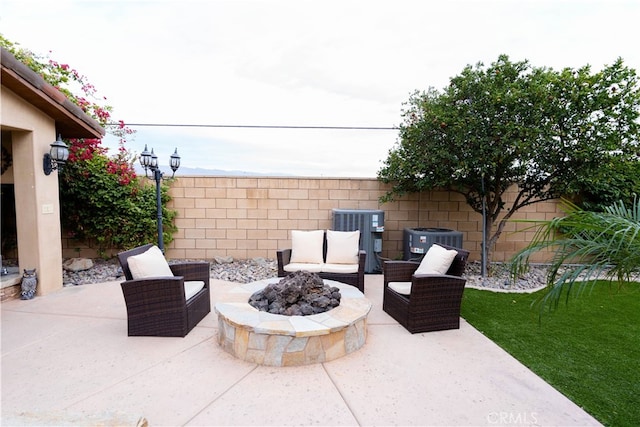 view of patio with an outdoor fire pit and central air condition unit
