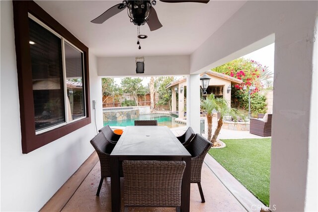 view of patio featuring a fenced in pool and ceiling fan
