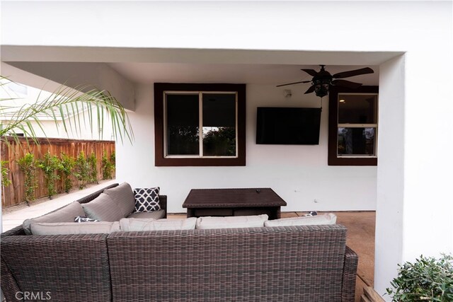 view of patio with an outdoor living space and ceiling fan