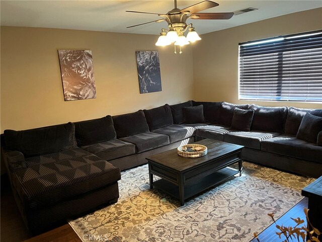 living room featuring hardwood / wood-style flooring and ceiling fan