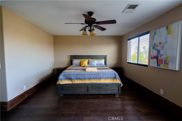 bedroom featuring dark hardwood / wood-style flooring and ceiling fan