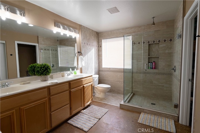 bathroom featuring vanity, toilet, tile patterned floors, and an enclosed shower