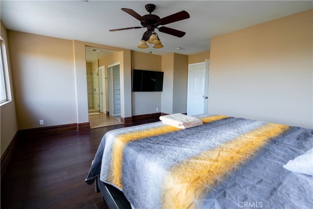 bedroom with ensuite bath, dark wood-type flooring, and ceiling fan