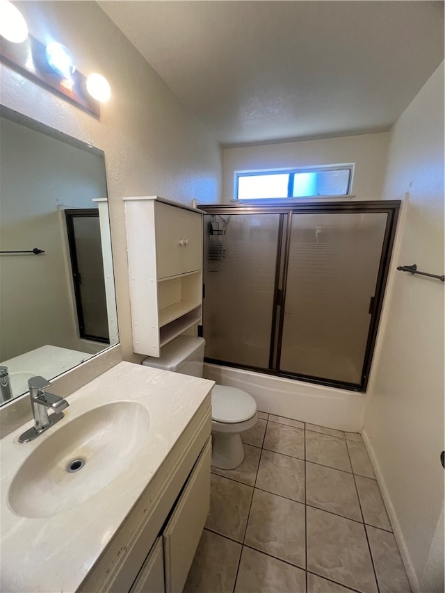 full bathroom featuring vanity, toilet, enclosed tub / shower combo, and tile patterned flooring