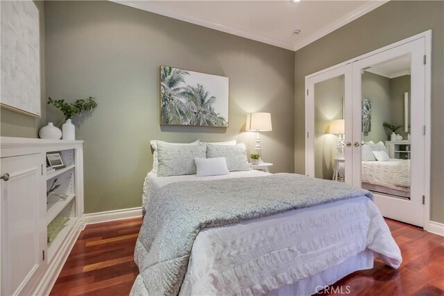 bedroom with french doors, dark wood-type flooring, and ornamental molding