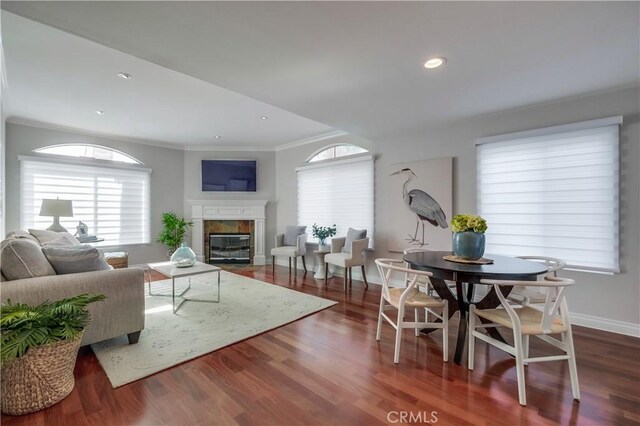 living room featuring dark wood-type flooring and ornamental molding