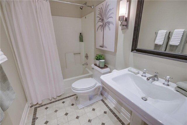 full bathroom featuring toilet, tile patterned flooring, shower / bath combination with curtain, and sink