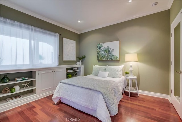 bedroom featuring hardwood / wood-style flooring and crown molding