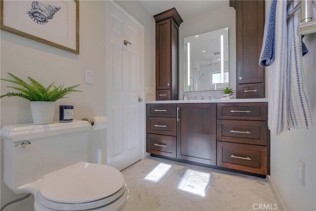 bathroom featuring toilet and vanity