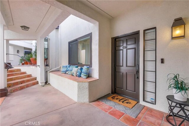 view of exterior entry with covered porch