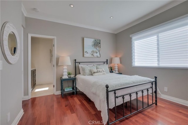 bedroom with ornamental molding and hardwood / wood-style floors