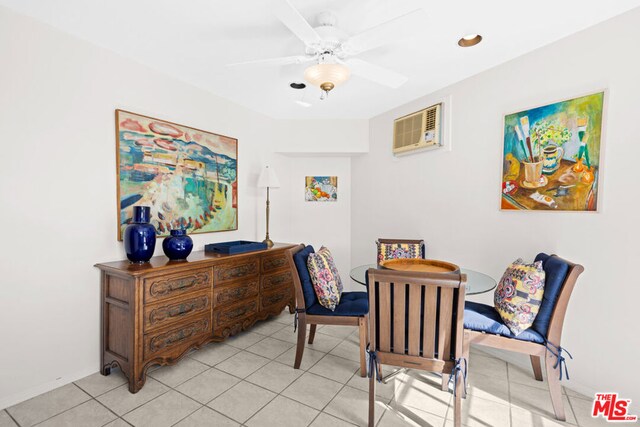 tiled dining room featuring a wall mounted air conditioner and ceiling fan