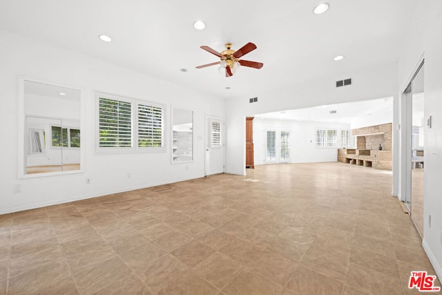 unfurnished living room with ceiling fan