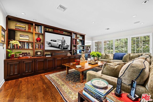 interior space featuring dark hardwood / wood-style flooring and ornamental molding