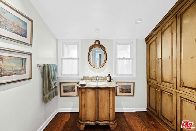 bathroom with vanity and hardwood / wood-style floors