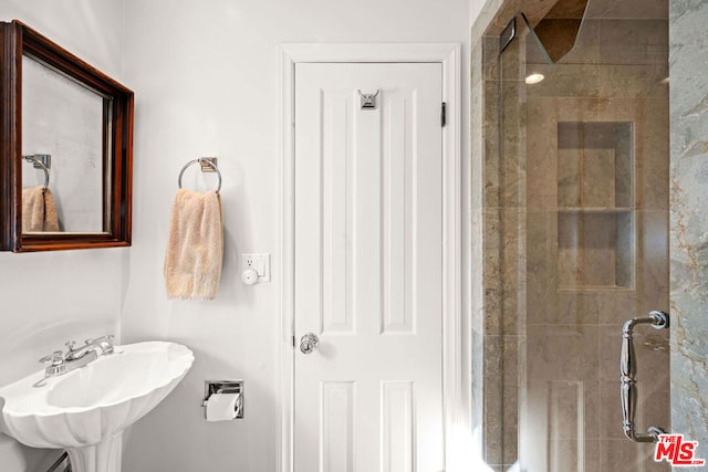 bathroom with sink and an enclosed shower