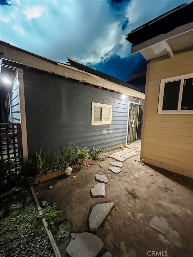 view of side of property featuring a patio area