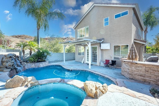 view of swimming pool featuring an in ground hot tub, a patio, and an outdoor bar