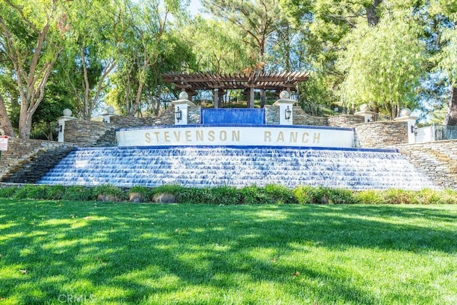 community sign featuring a lawn