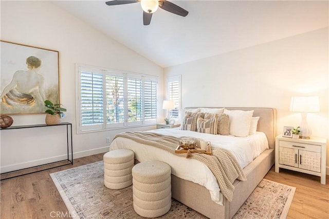 bedroom with light hardwood / wood-style flooring, ceiling fan, and lofted ceiling