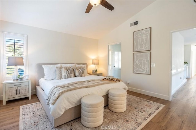 bedroom featuring vaulted ceiling, light hardwood / wood-style flooring, and ceiling fan