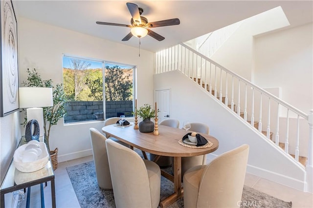 tiled dining room featuring ceiling fan