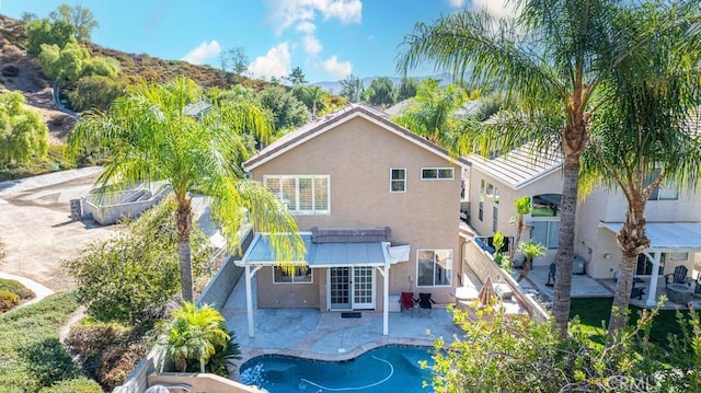 rear view of property with a patio area and french doors