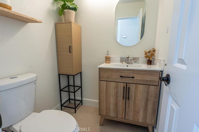 bathroom with tile patterned floors, vanity, and toilet