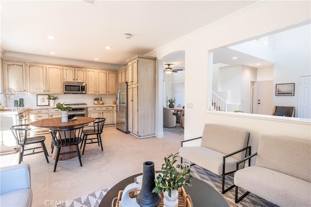 interior space featuring ceiling fan, light tile patterned floors, light brown cabinetry, tasteful backsplash, and stainless steel appliances