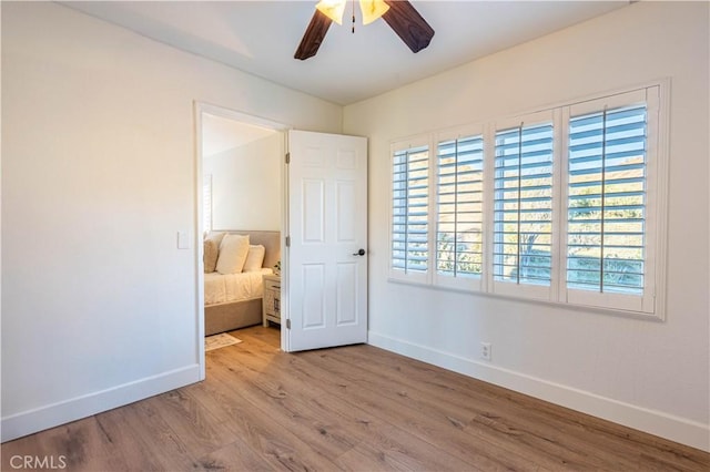 unfurnished bedroom featuring ceiling fan and light wood-type flooring