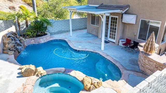 view of pool featuring an in ground hot tub, french doors, and a patio