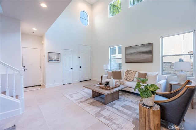 tiled living room with a high ceiling