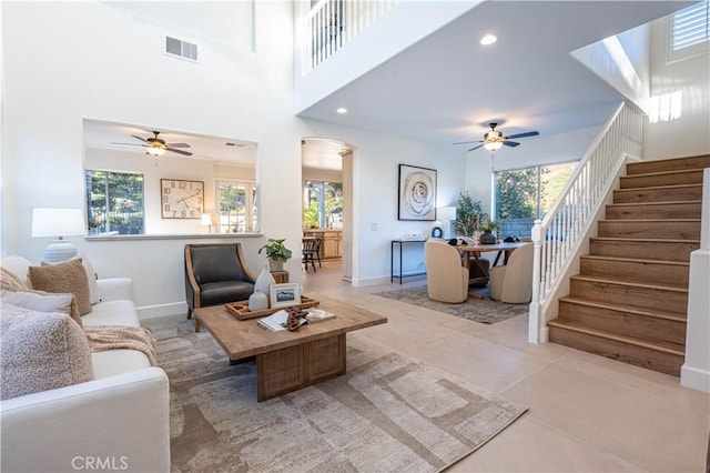 living room with ceiling fan and light tile patterned floors