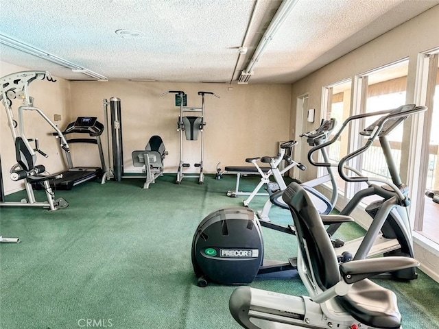 exercise room with a textured ceiling