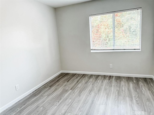 spare room with light hardwood / wood-style floors