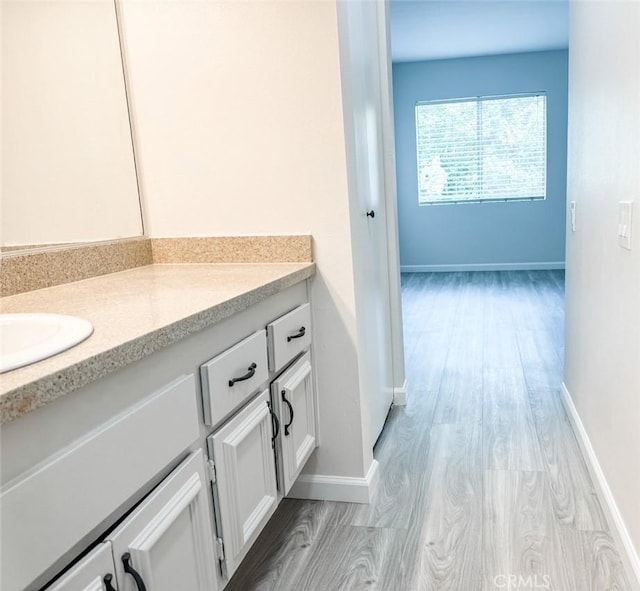 bathroom featuring wood-type flooring and vanity