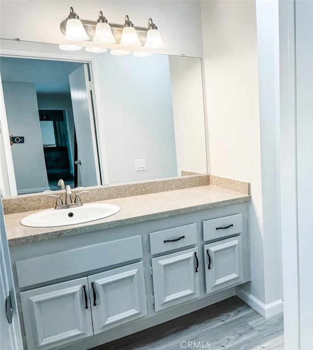 bathroom with hardwood / wood-style flooring and vanity