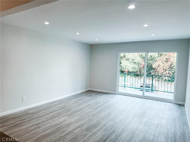 unfurnished room with light wood-type flooring