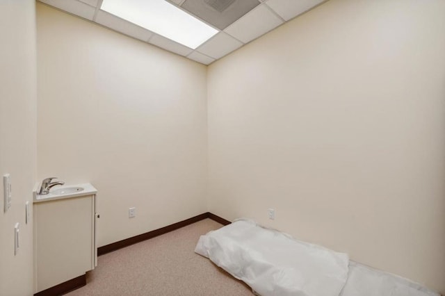 spare room with carpet and a paneled ceiling