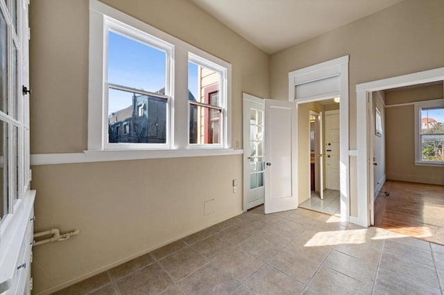 interior space with light tile patterned floors, french doors, and a wealth of natural light