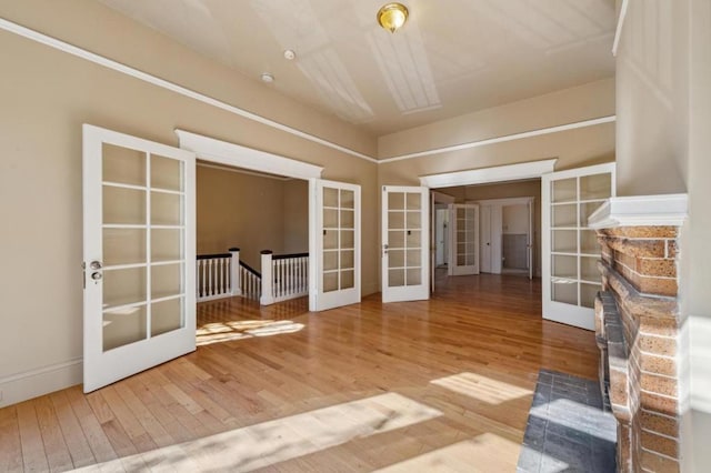 unfurnished room featuring french doors and hardwood / wood-style floors