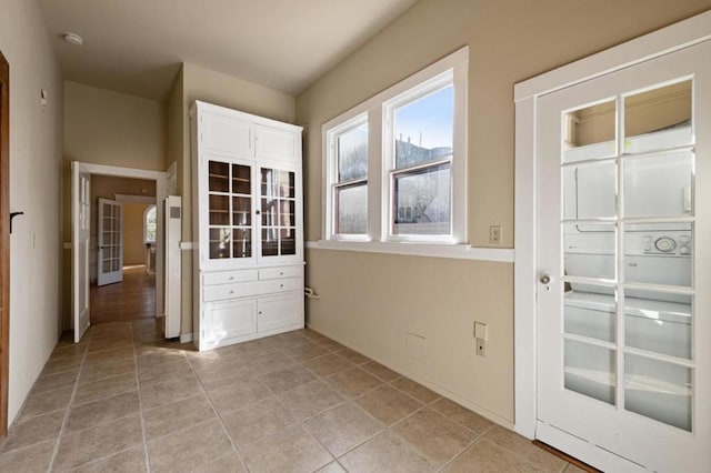 doorway with light tile patterned floors