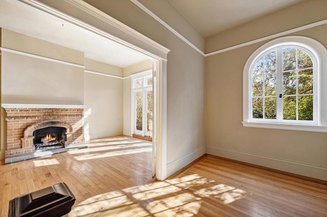 unfurnished living room with a brick fireplace and hardwood / wood-style floors