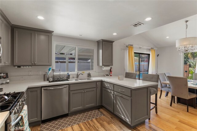 kitchen with a healthy amount of sunlight, kitchen peninsula, and appliances with stainless steel finishes