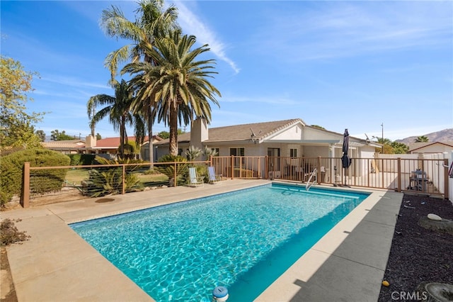 view of pool with a fenced in pool, fence, and a patio area
