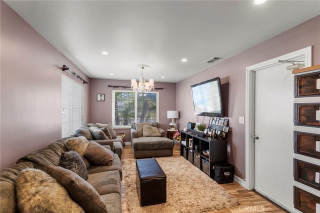 living area featuring recessed lighting, a notable chandelier, visible vents, and light wood-type flooring