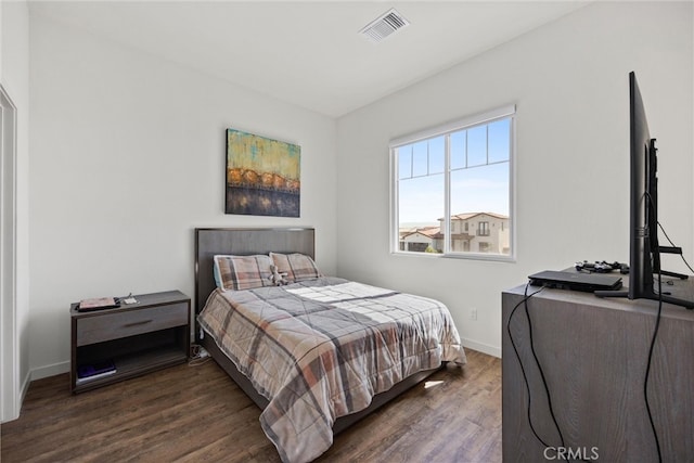 bedroom with dark hardwood / wood-style flooring