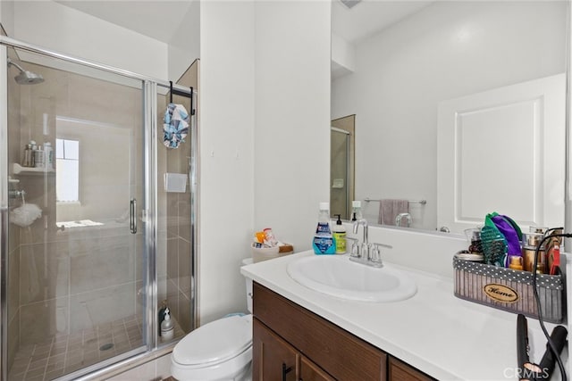 bathroom with vanity, toilet, and an enclosed shower