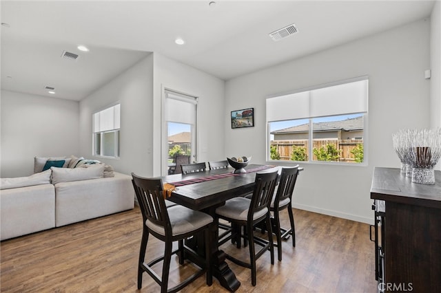 dining space featuring hardwood / wood-style flooring and plenty of natural light